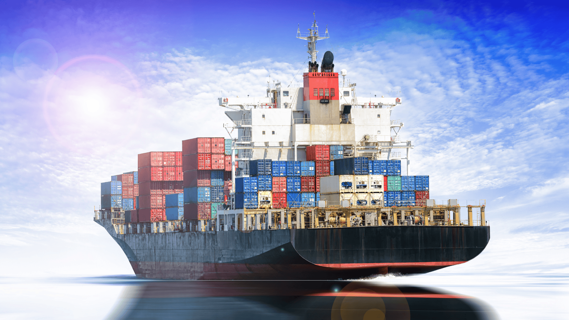 Centered, stylized image of a massive container ship loaded with cargo against a bright blue sky.